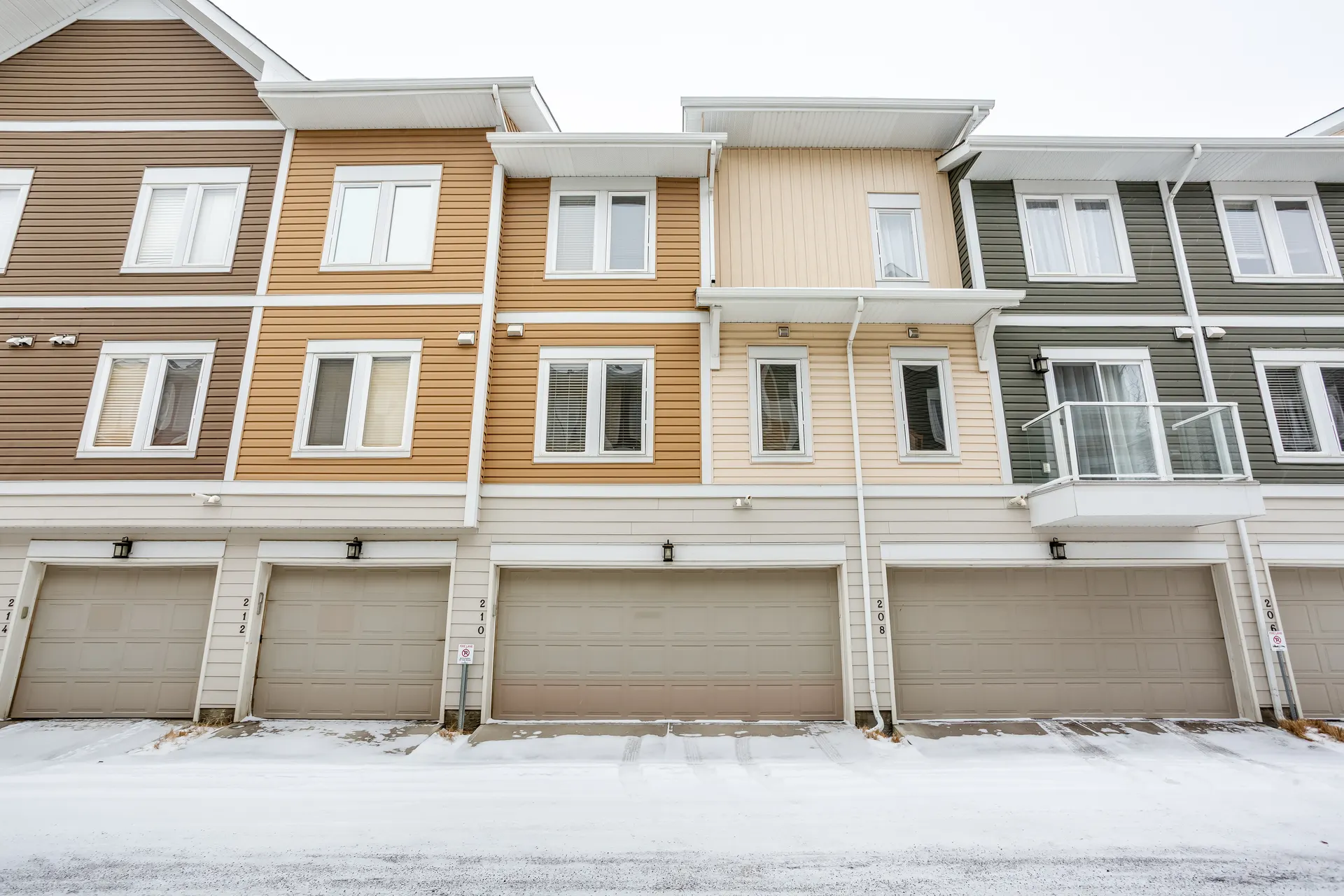 Rear-lane townhomes with attached garages in Auburn Bay, Calgary SE