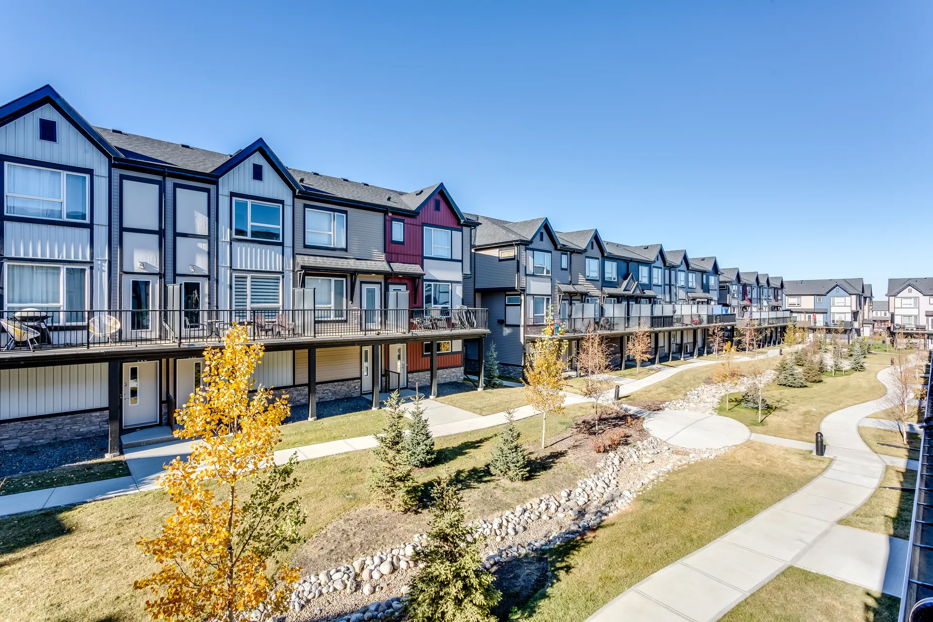 Rows of townhomes and a pathway seen from an upper balcony in Belmont