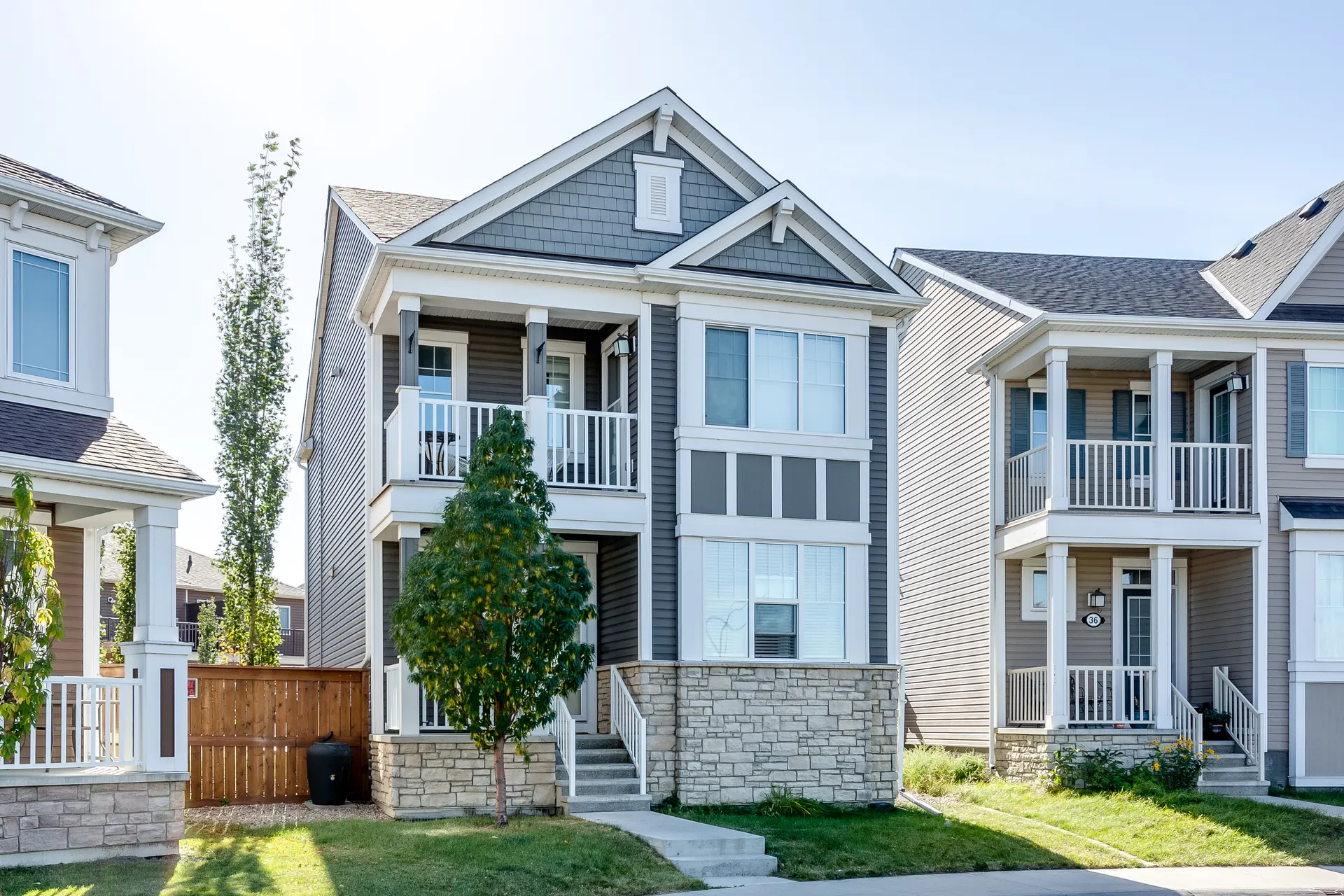 Row of two-storey homes with mature trees in Cityscape, Calgary NE