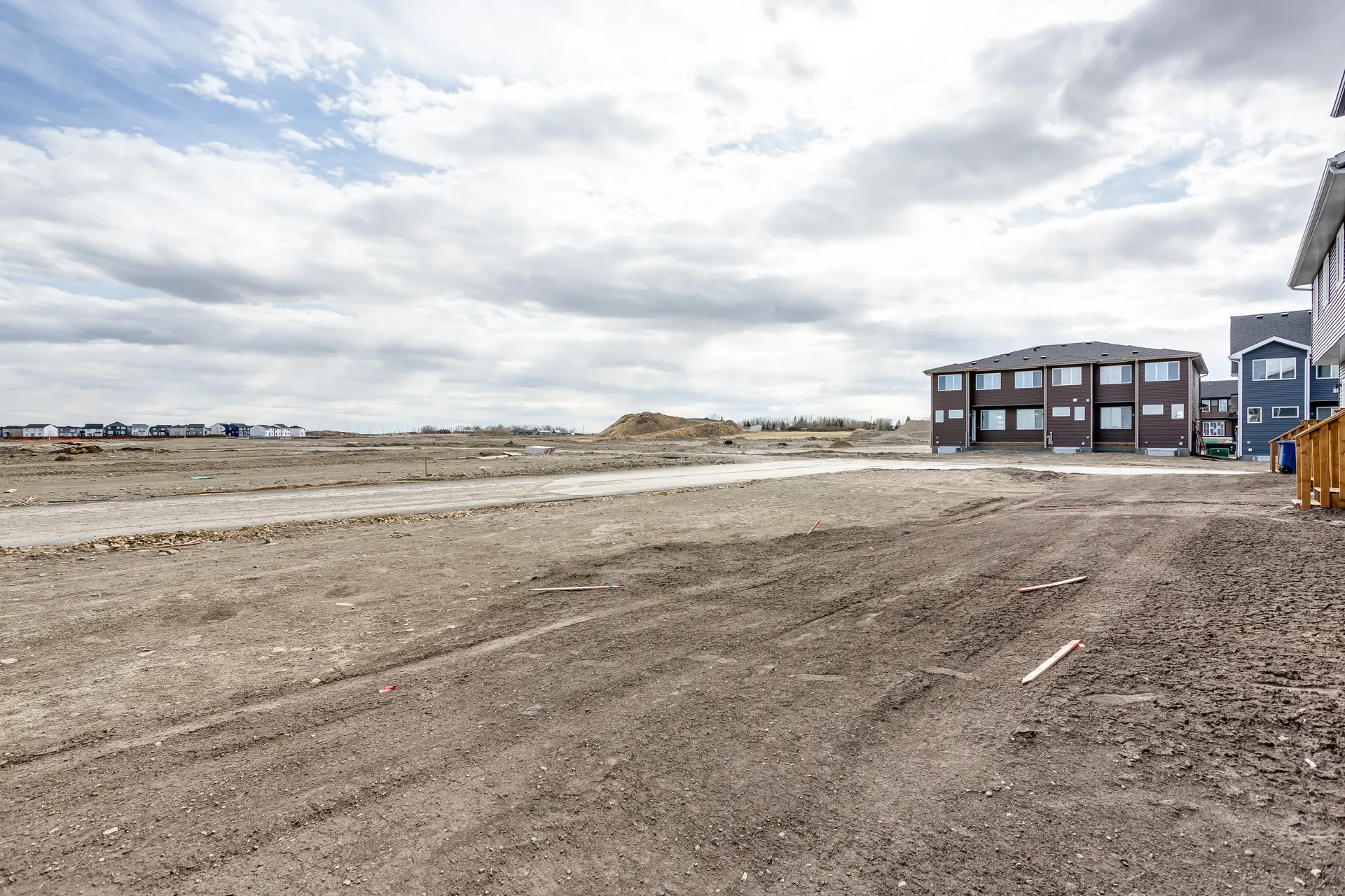 Graded land and new homes on the edge of Cobblestone Creek, Airdrie