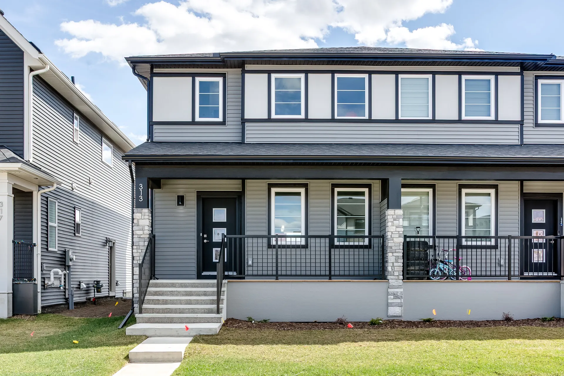 New two-storey paired home with front porch on Cobblestone Gate SW, Airdrie