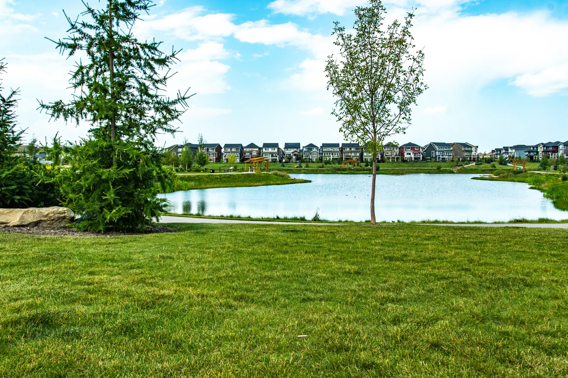 Neighbourhood pond and homes in Cochrane Alberta