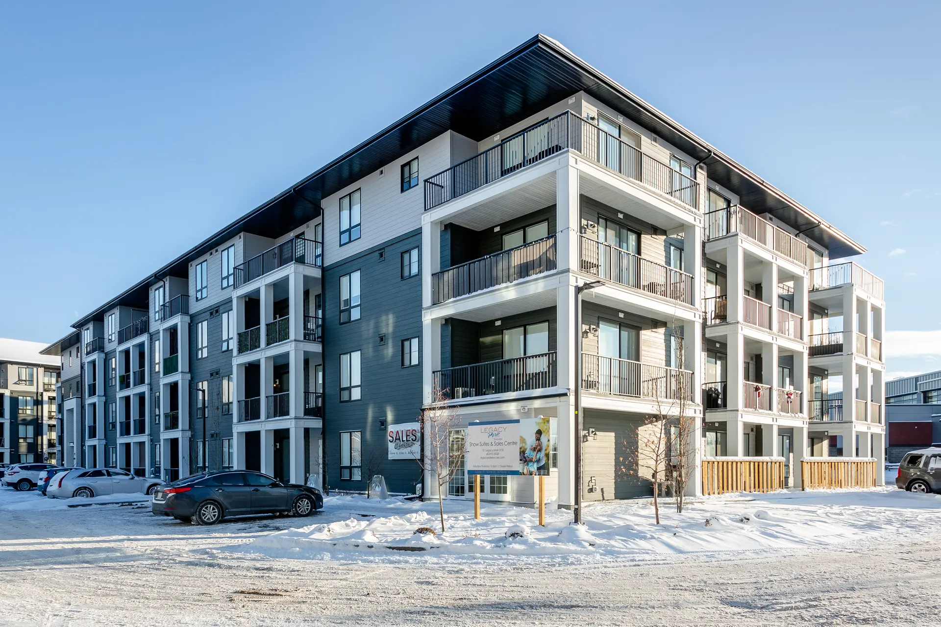 Four-storey apartment building with balconies at Legacy Village Road SE in winter