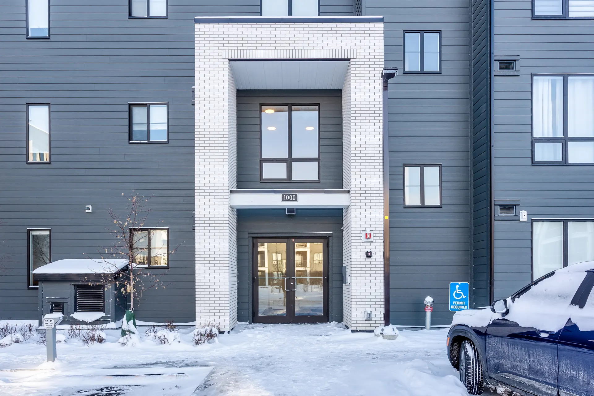 Entrance to a low-rise condominium building in Legacy, Calgary SE