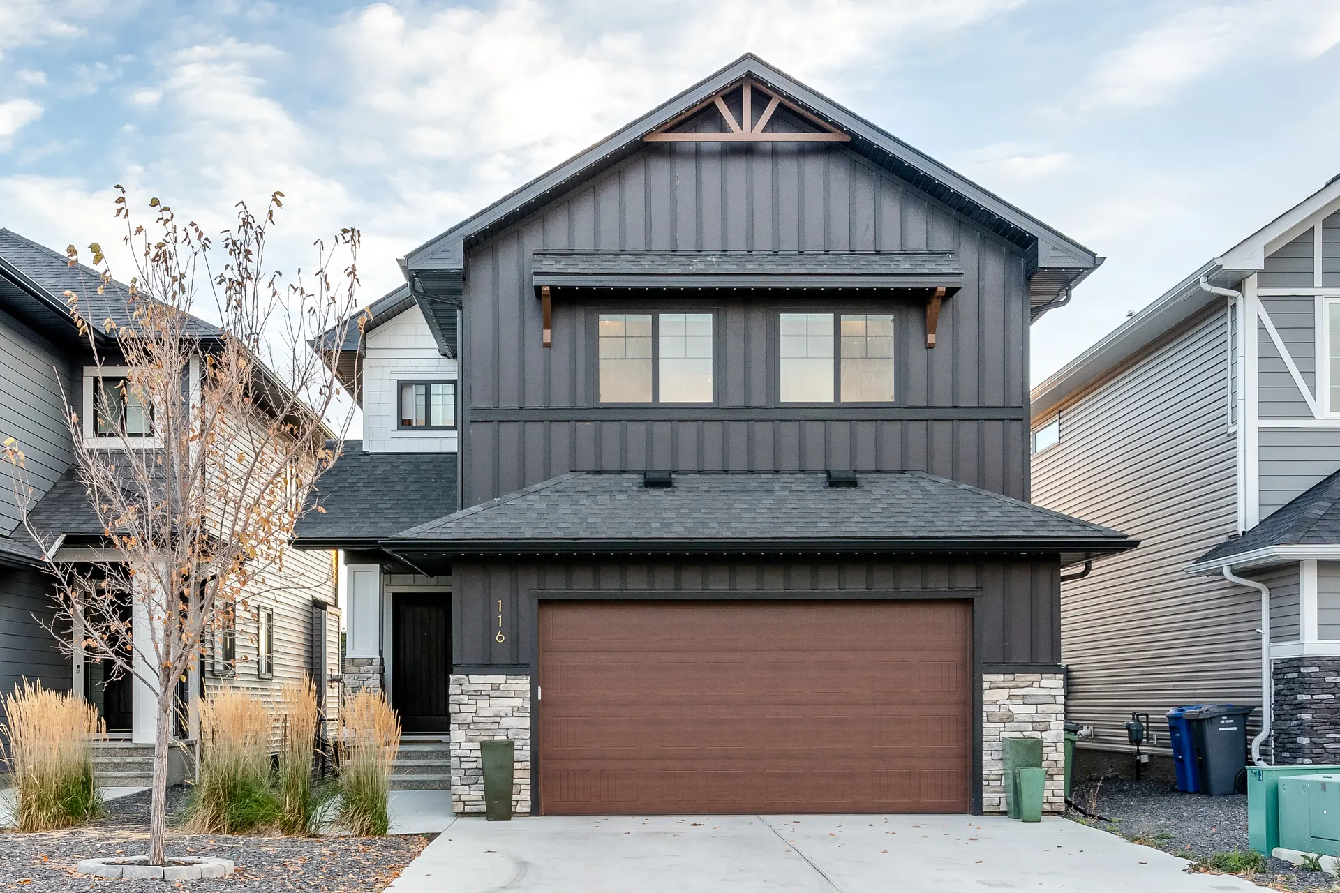 Two-storey home with double balcony and stone base on Ranchers View, Okotoks