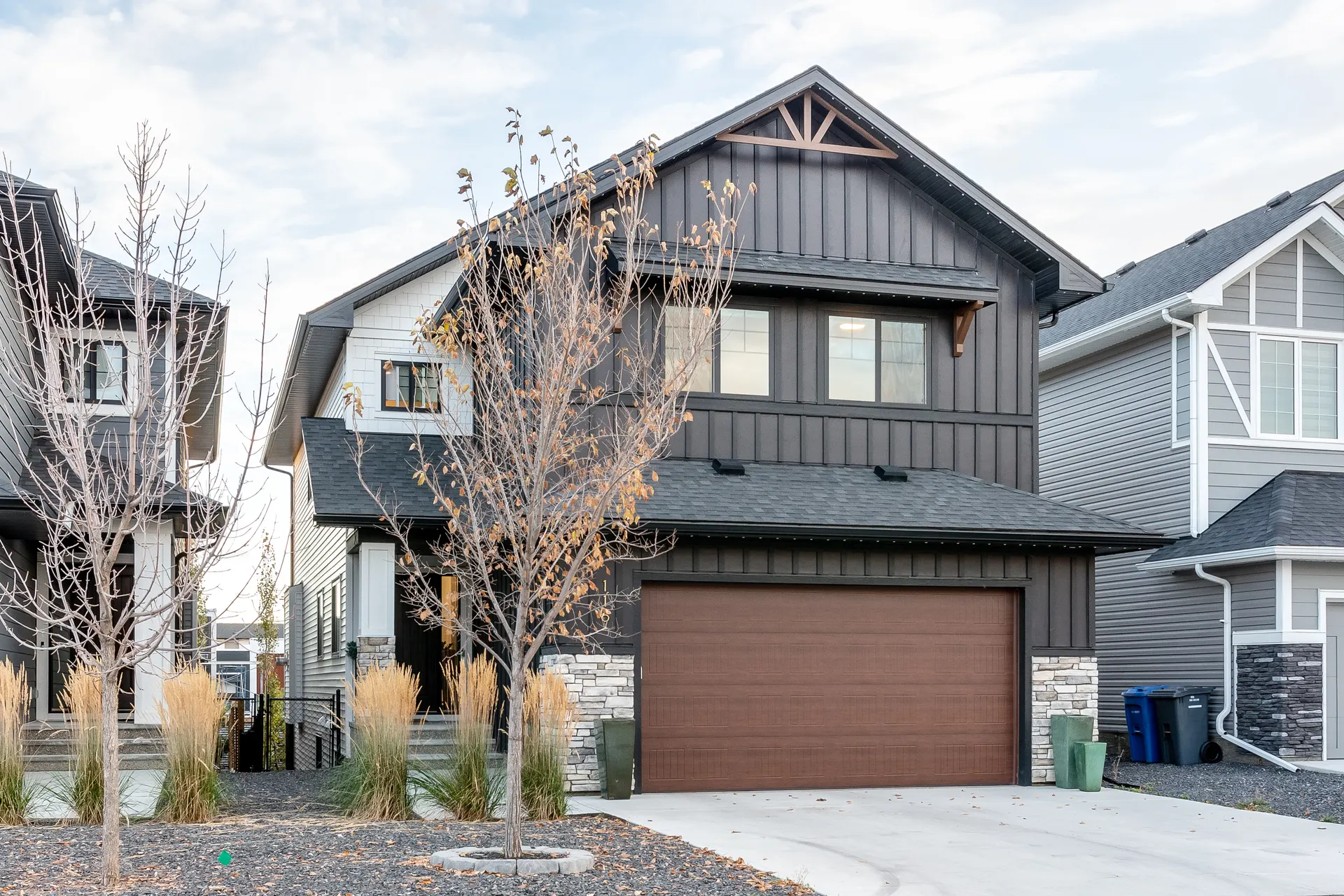 Newer homes with maturing trees along Ranchers View in Okotoks