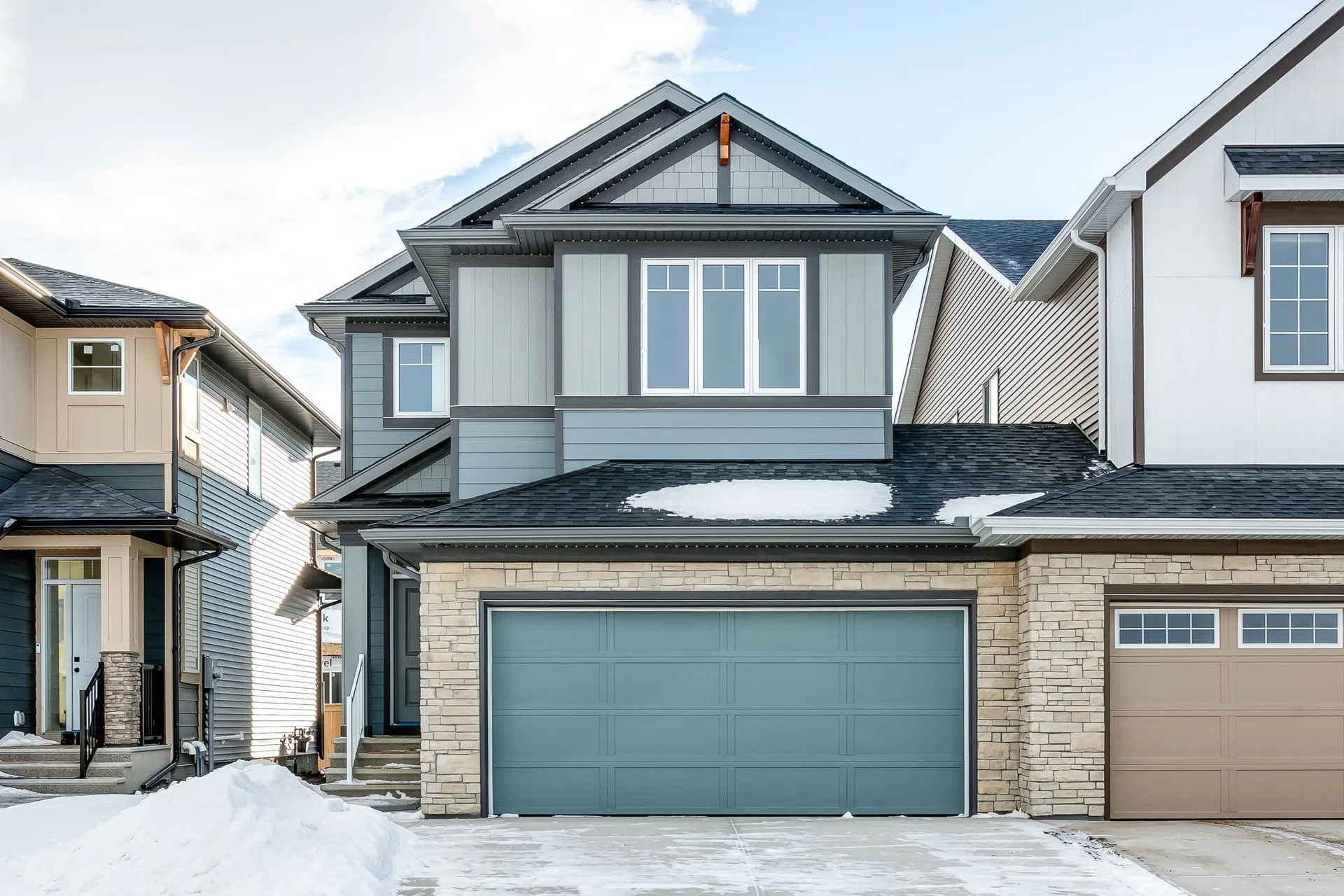 New front-drive home with double garage on Creekside Passage SW, Pine Creek, in winter