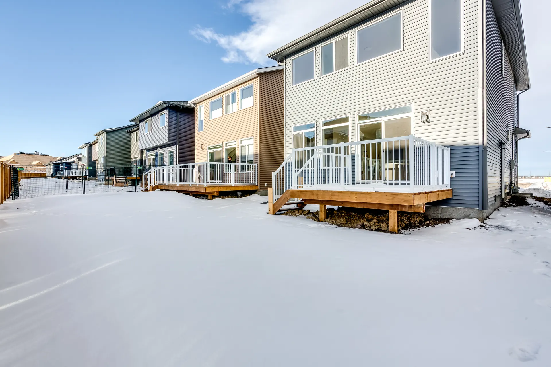 Rear of new homes with decks and homes under construction in Pine Creek