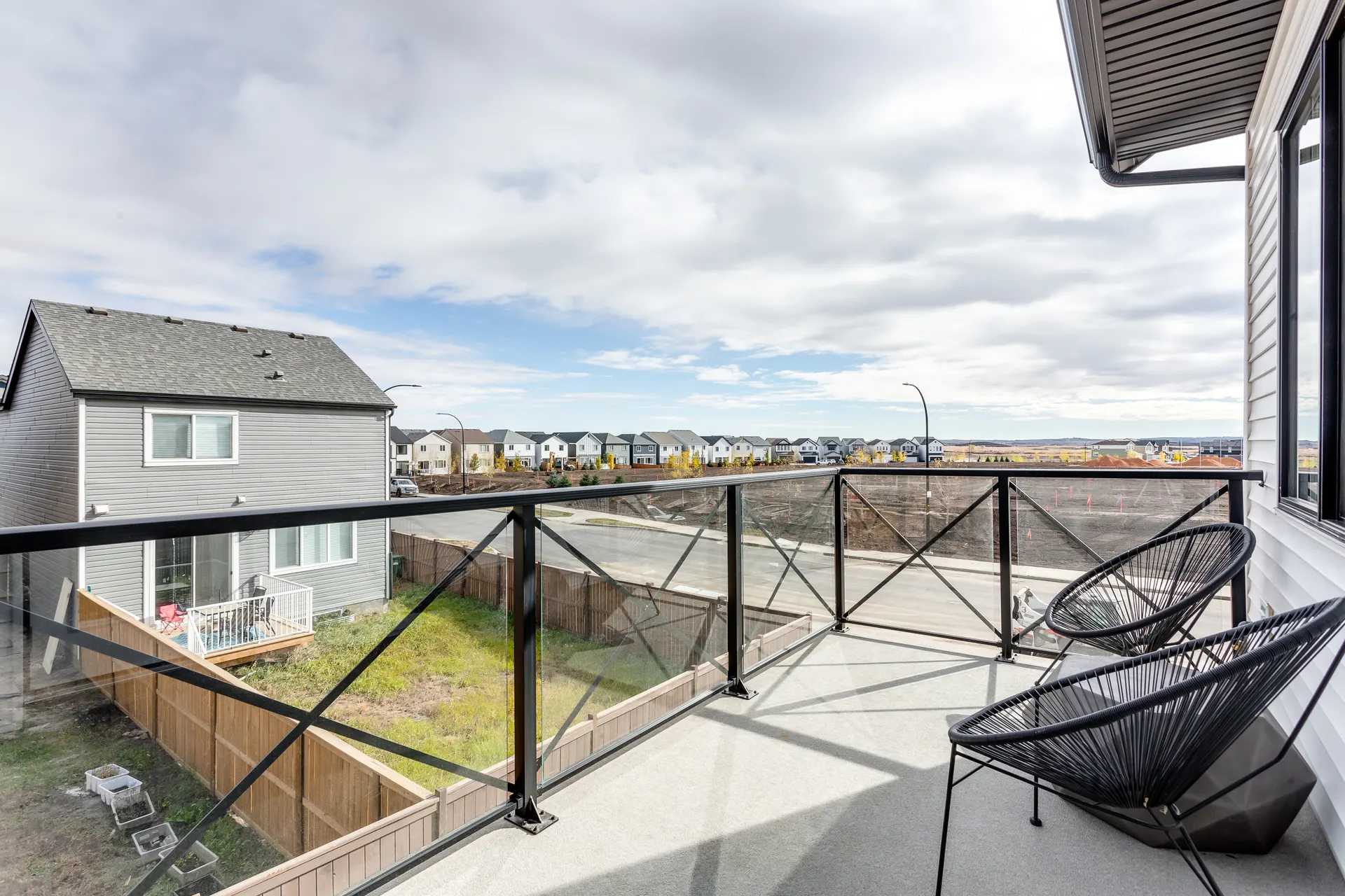 Balcony outlook toward homes and developing land in Rangeview