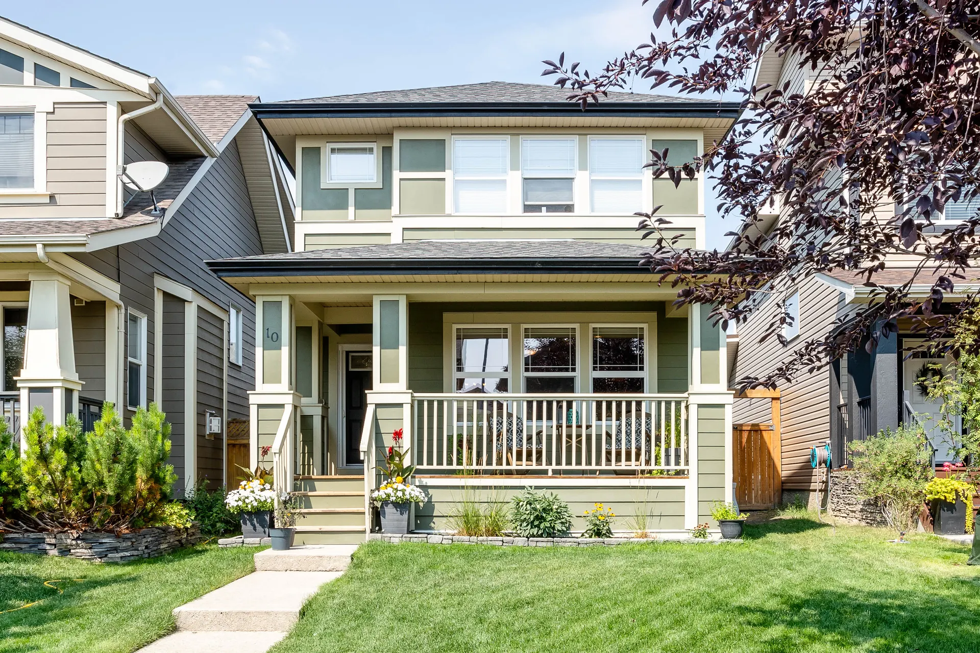 Two-storey front-porch home with green siding on Walden Road SE