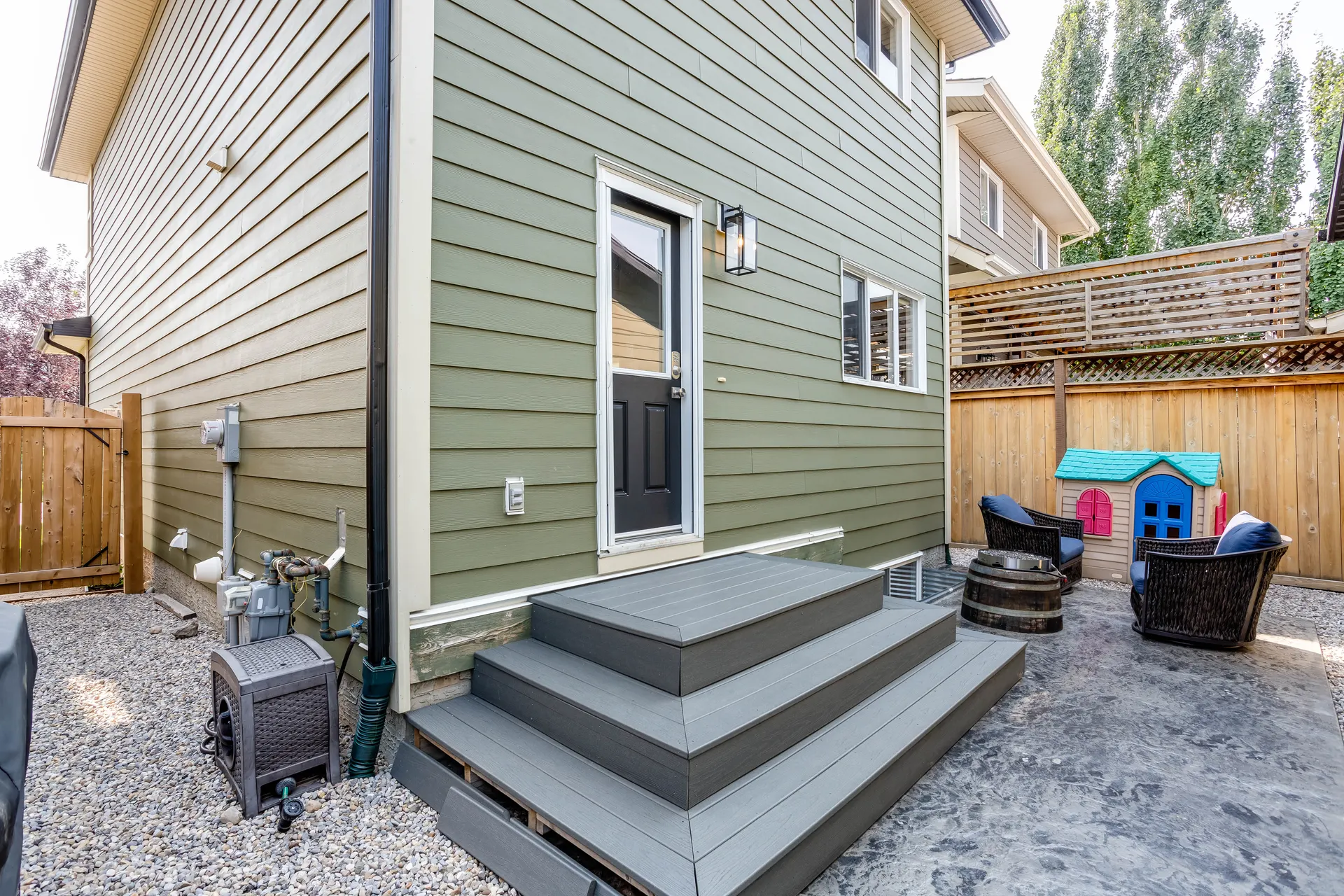 Fenced rear yard and detached garage in Walden, Calgary